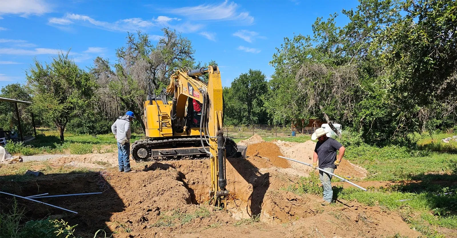 Backhoe performing excavation and site work on a job site