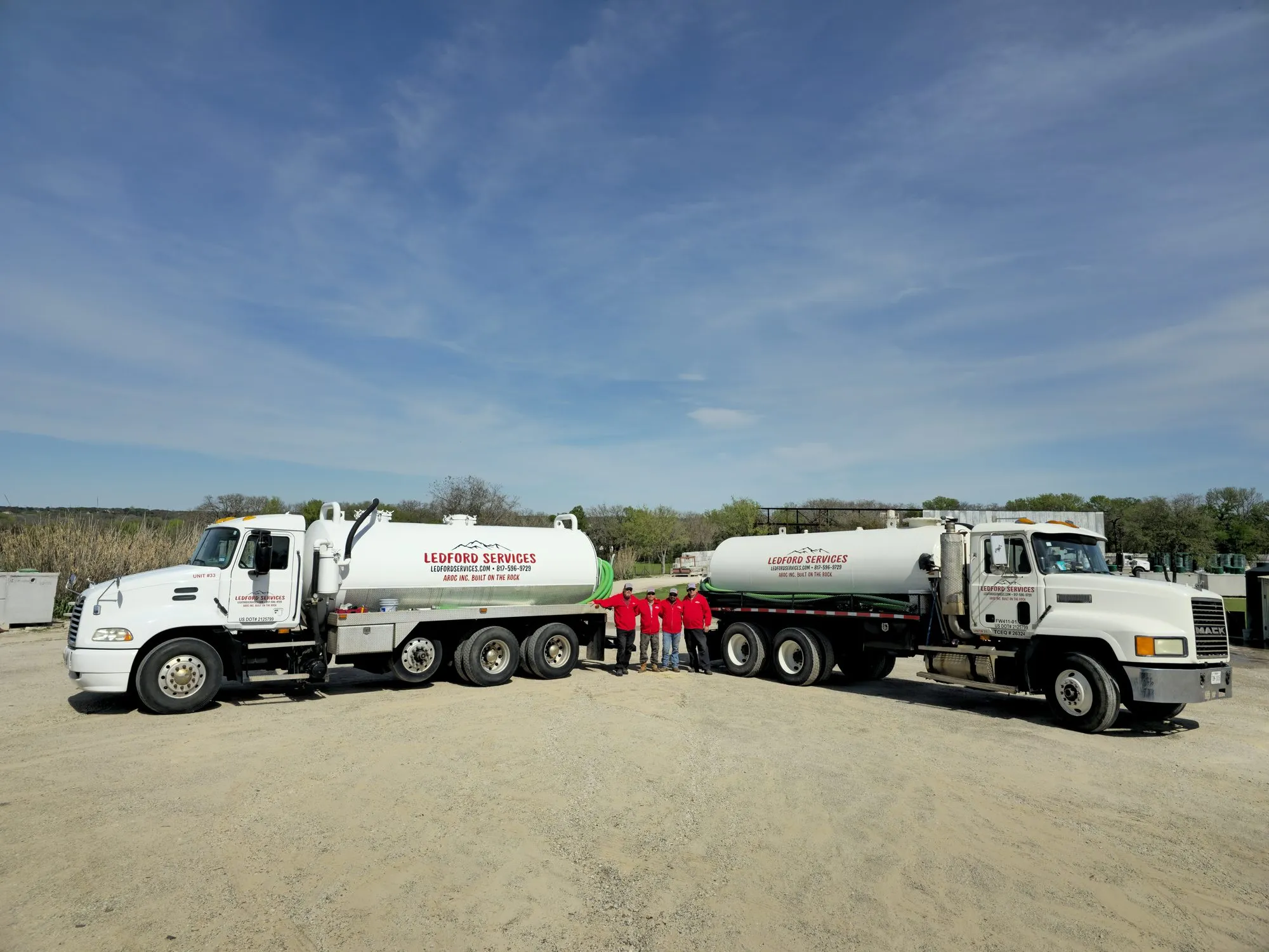 Two Ledford Services vacuum trucks with the pumping crew at the Aledo yard