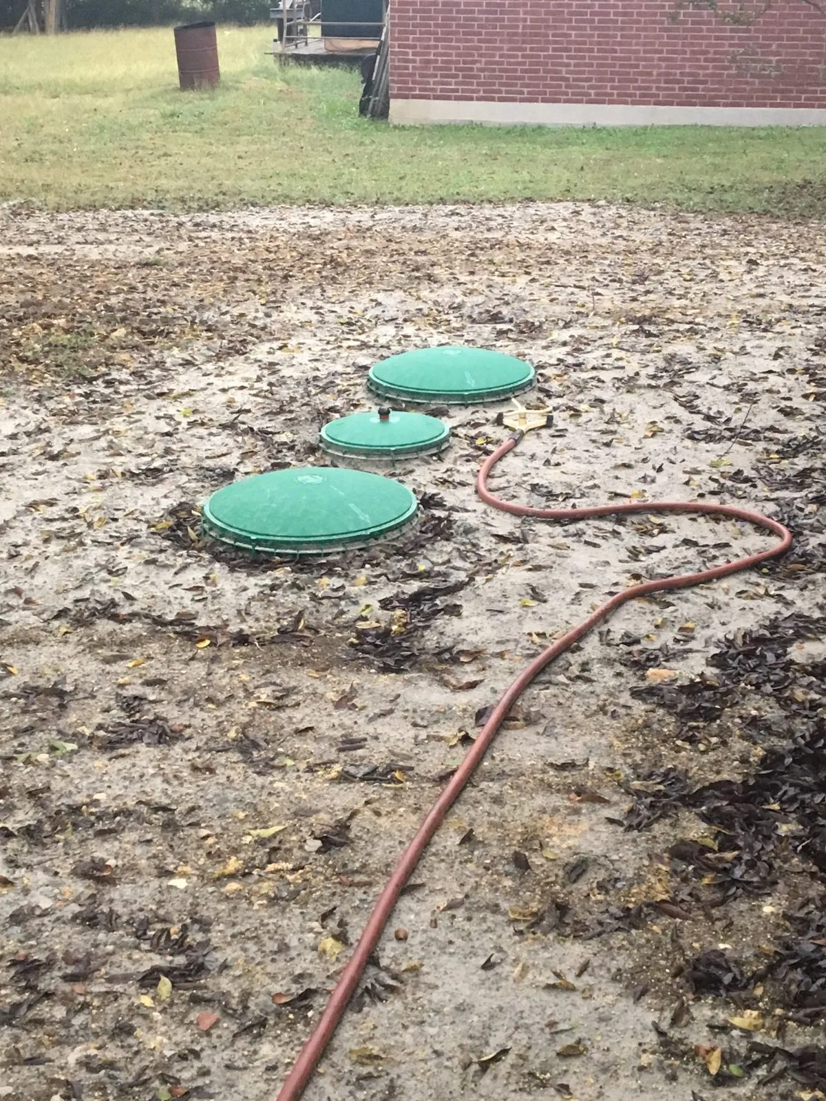 Septic tank lids exposed during pumping service