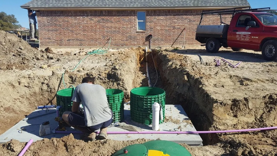 Technician servicing an aerobic septic system