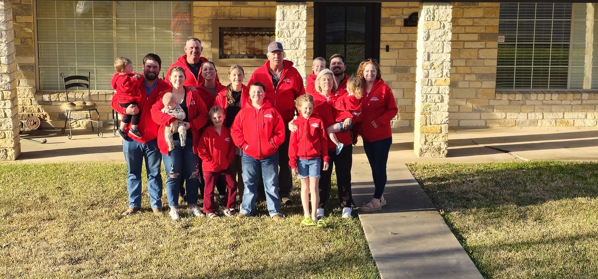 The Ledford family and team gathered outside in Ledford Services jackets