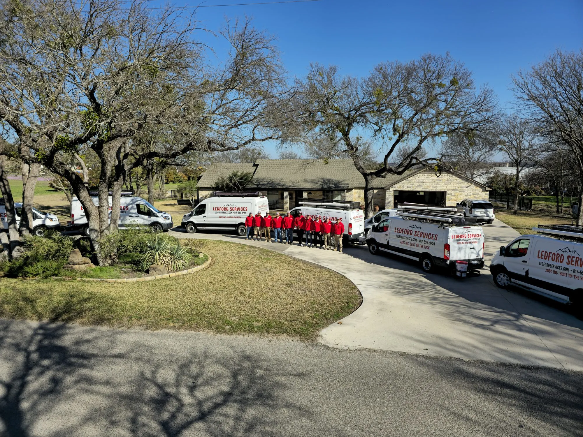 The Ledford Services crew lined up with the service fleet outside the Aledo office